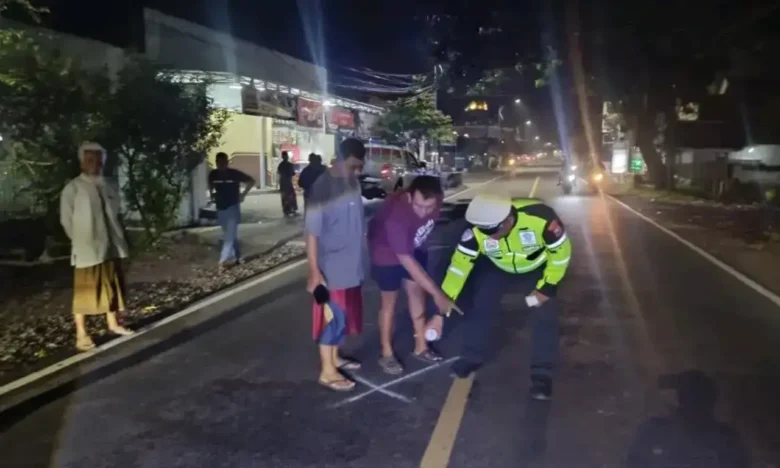 Piket lantas Polsek Gambiran, saat lakukan olah TKP insiden lakalantas truk kontra motor, di Jalan Raya Jember-Banyuwangi yang mengakibatkan satu korban tewas di tempat, Senin (4/5/2026) malam (foto: Blok-a.com/Kuryanto)